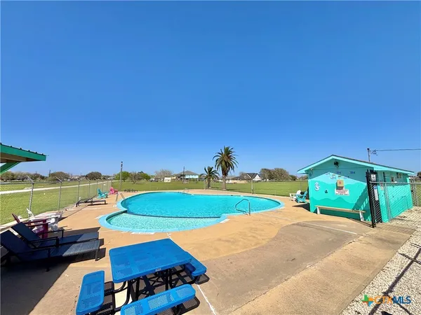 a view of a swimming pool with a yard