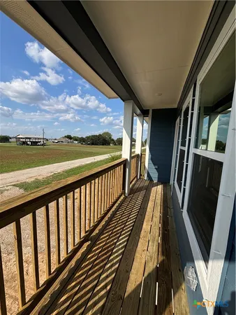 a view of balcony with wooden floor and ocean view