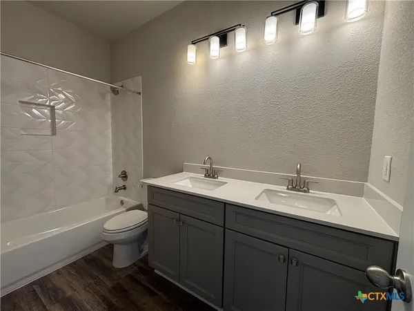 a bathroom with a sink toilet a mirror and shower