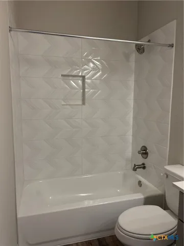 a bathroom with a double vanity sink toilet and a mirror