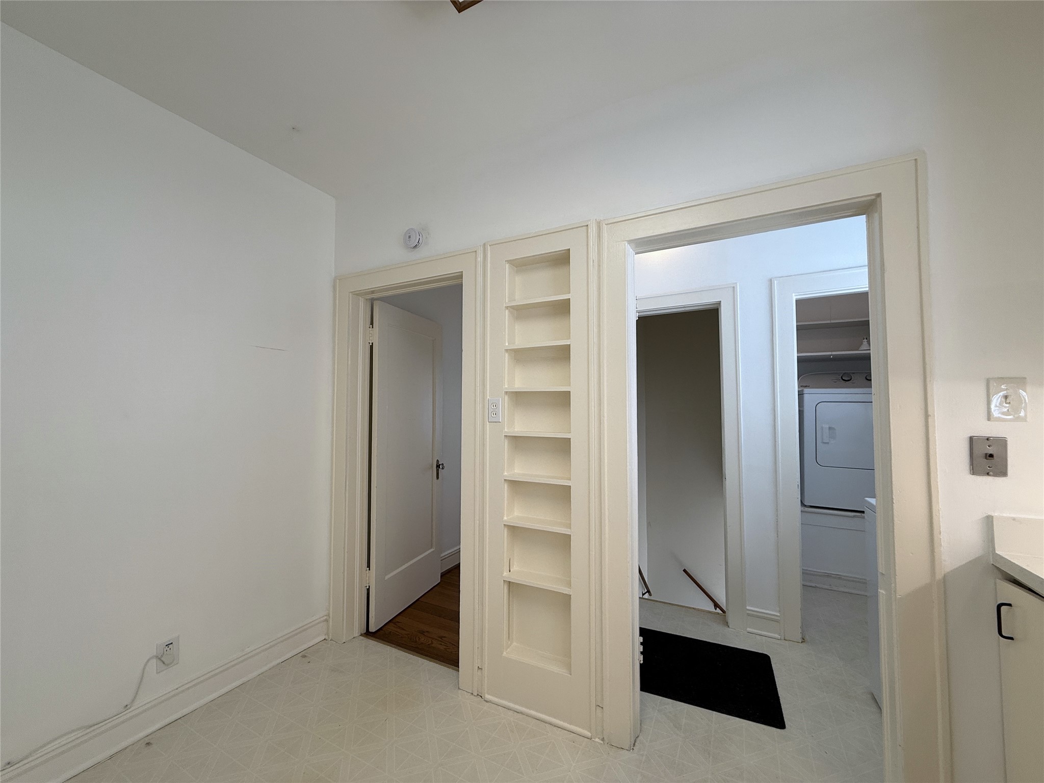 2311 Wroxton Road Houston, TX 77005 - Photo 14 of 24 To the left of the built-in spice rack, a privacy door opens into hallway leading to the bedrooms & bathroom.