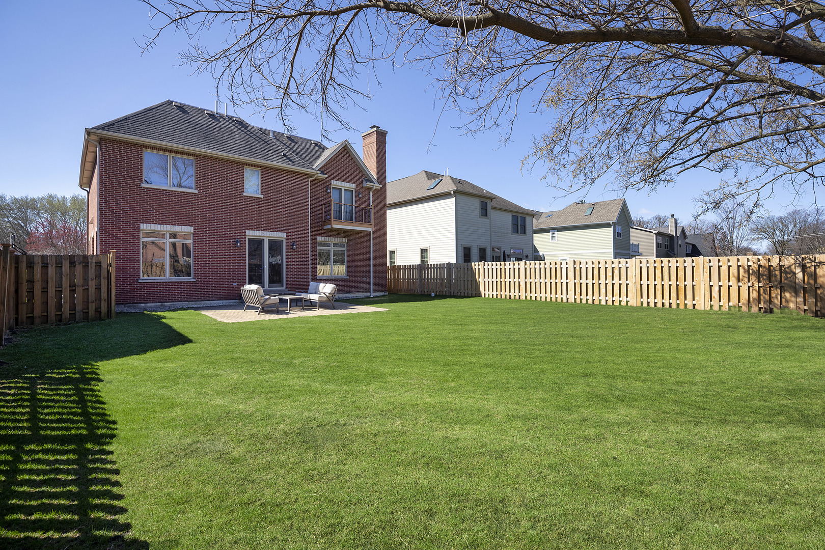2026 Maple Avenue Northbrook, IL 60062 - Photo 17 of 18 a front view of a house with a garden and yard