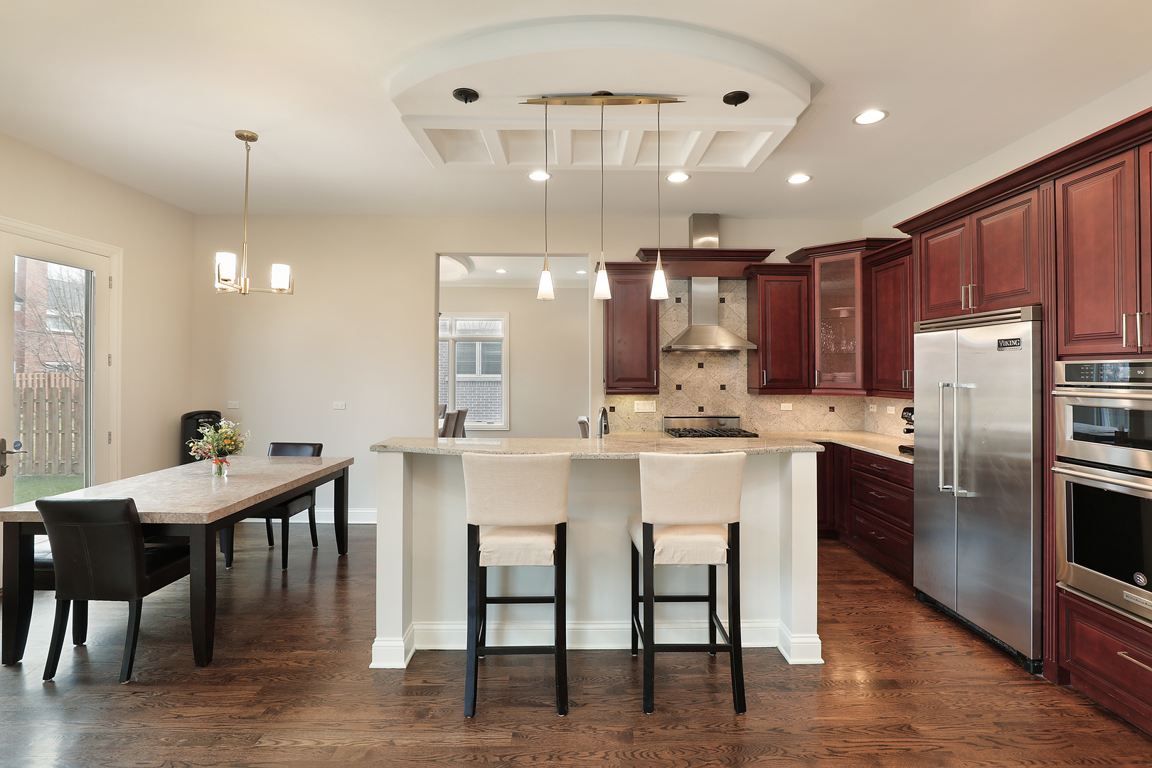 2026 Maple Avenue Northbrook, IL 60062 - Photo 4 of 18 a kitchen with kitchen island a dining table chairs stainless steel appliances and cabinets