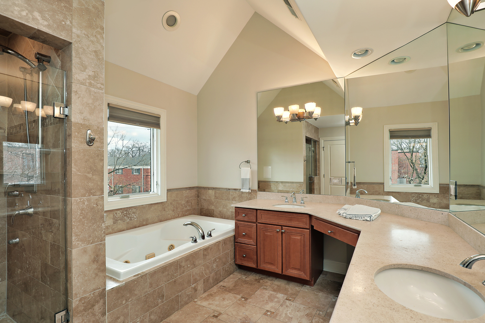 2026 Maple Avenue Northbrook, IL 60062 - Photo 9 of 18 a bathroom with a tub a double vanity sink and a large mirror