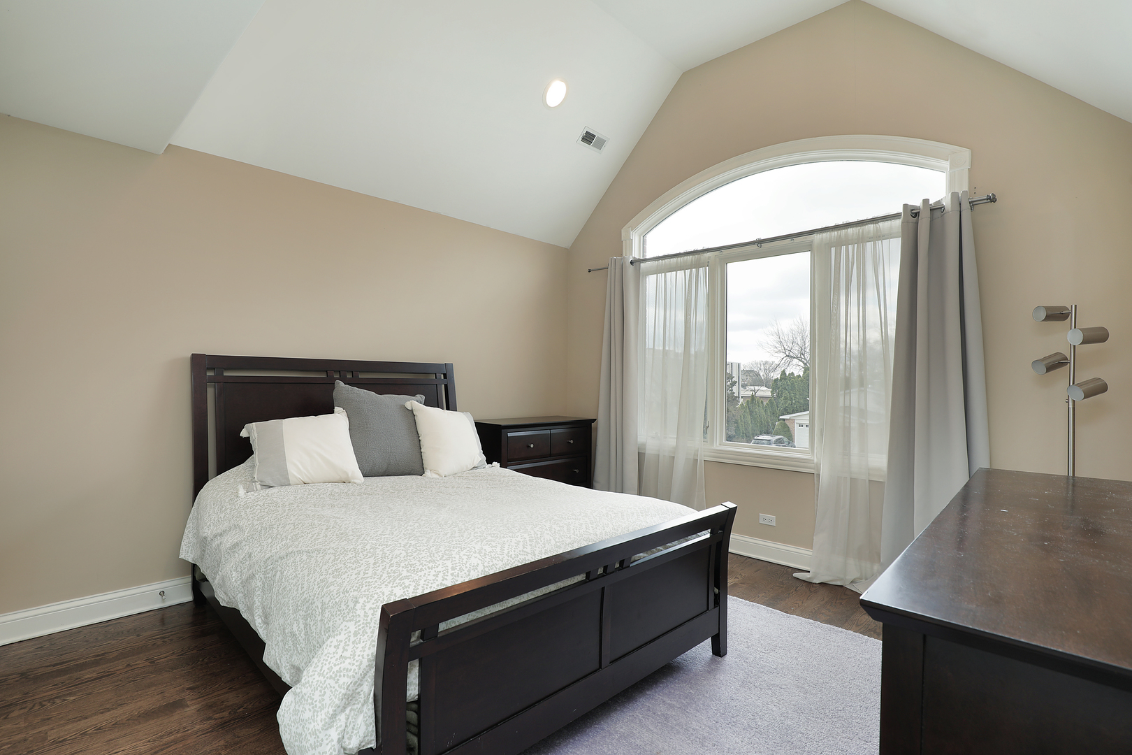 2026 Maple Avenue Northbrook, IL 60062 - Photo 10 of 18 a large bed sitting in a bedroom next to a window