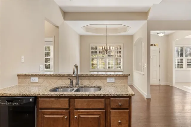 a kitchen with granite countertop a sink and cabinets