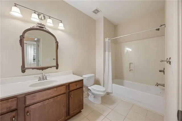 a bathroom with a double vanity sink toilet and shower