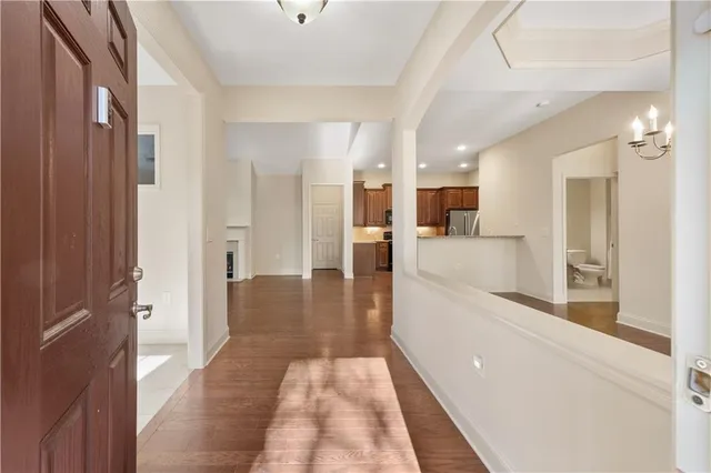 a view of a big room with wooden floor and windows