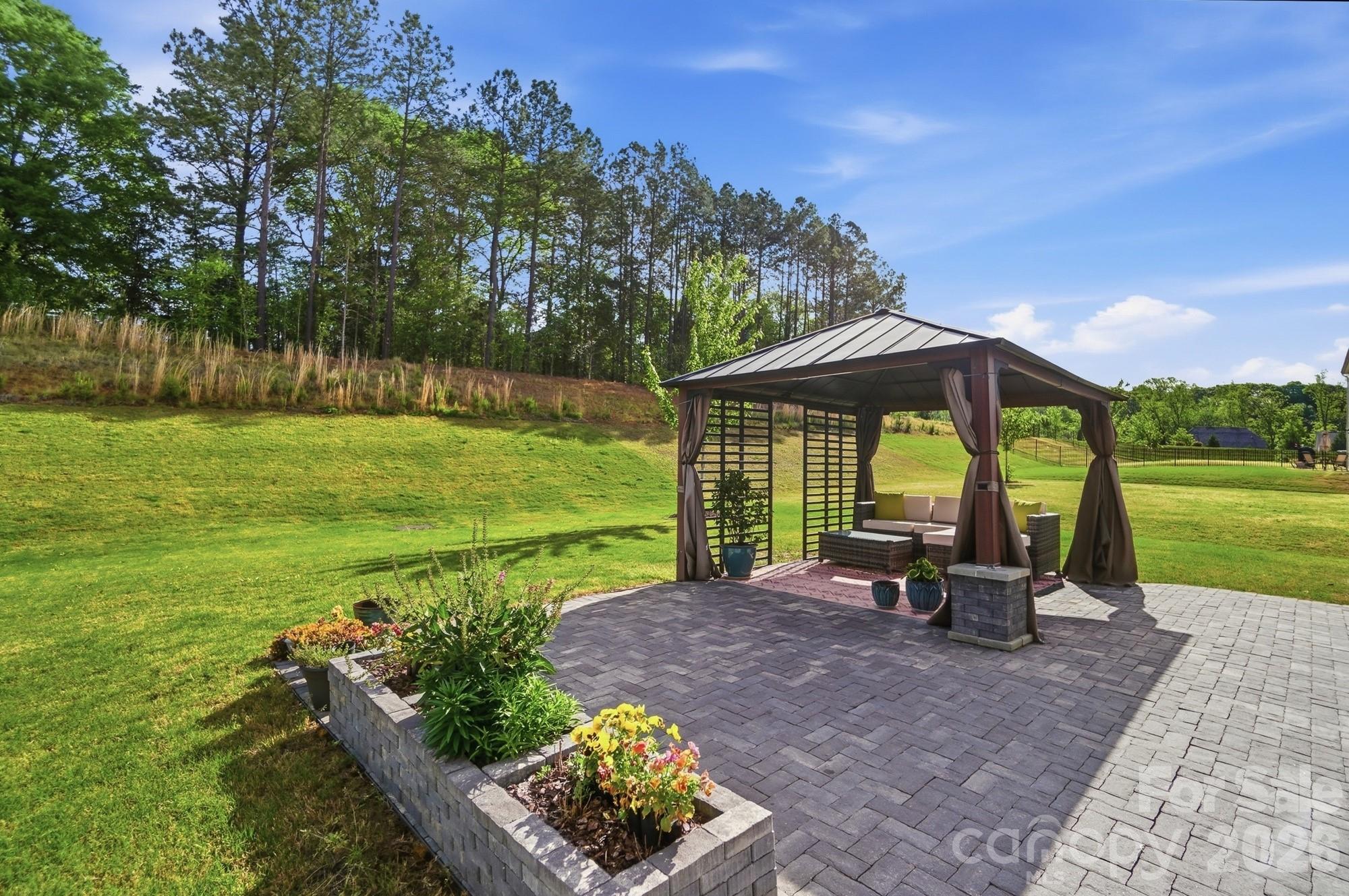 116 Timbergreen Court Troutman, NC 28166 - Photo 6 of 43 a view of a park with lounge chairs in patio