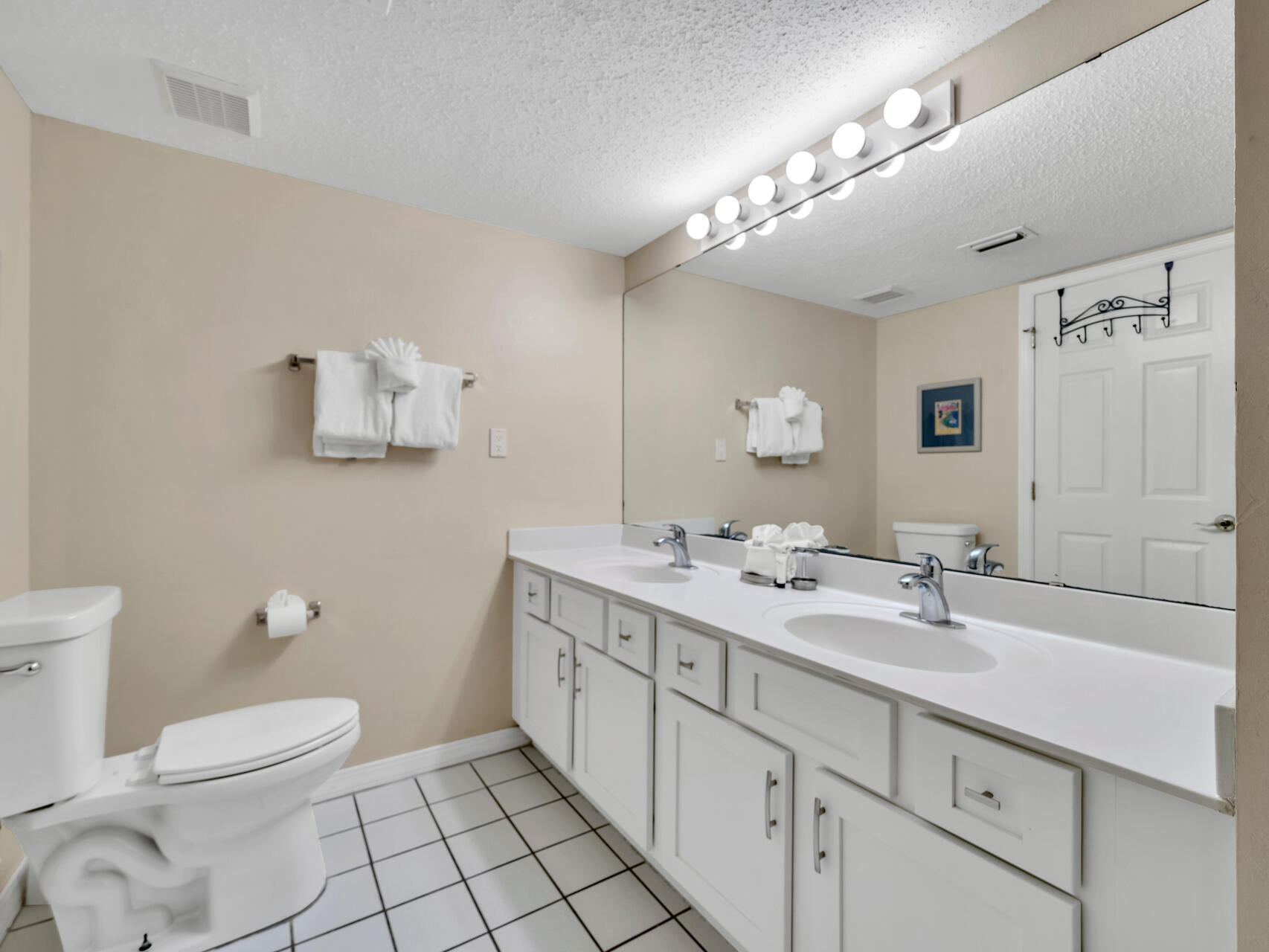 790 Santa Rosa Boulevard, Unit 6002 Fort Walton Beach, FL 32548 - Photo 20 of 42 a spacious bathroom with a double vanity sink toilet and a mirror