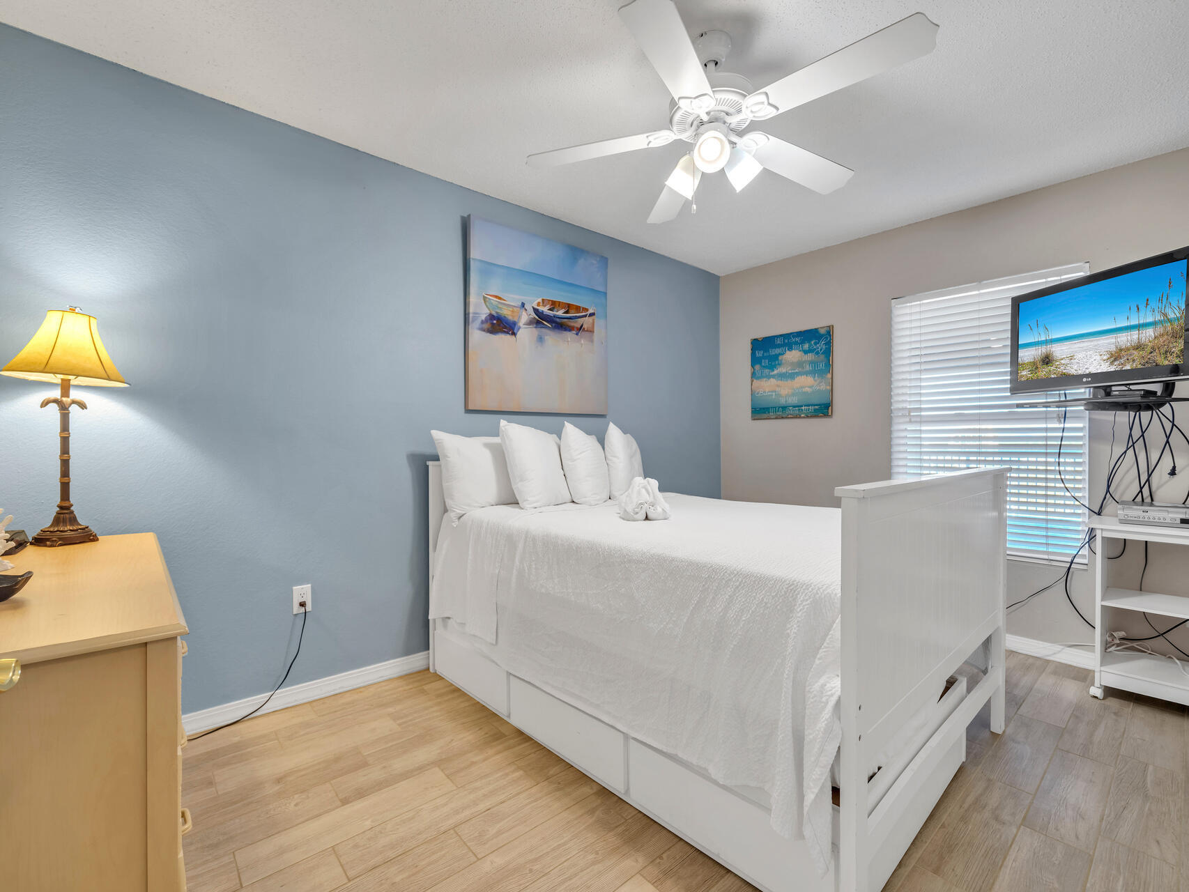 790 Santa Rosa Boulevard, Unit 6002 Fort Walton Beach, FL 32548 - Photo 22 of 42 a bedroom with a bed and a chandelier