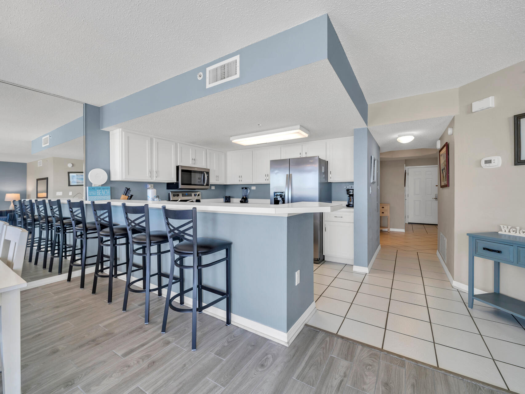 790 Santa Rosa Boulevard, Unit 6002 Fort Walton Beach, FL 32548 - Photo 5 of 42 a view of kitchen with sink dining table and chairs