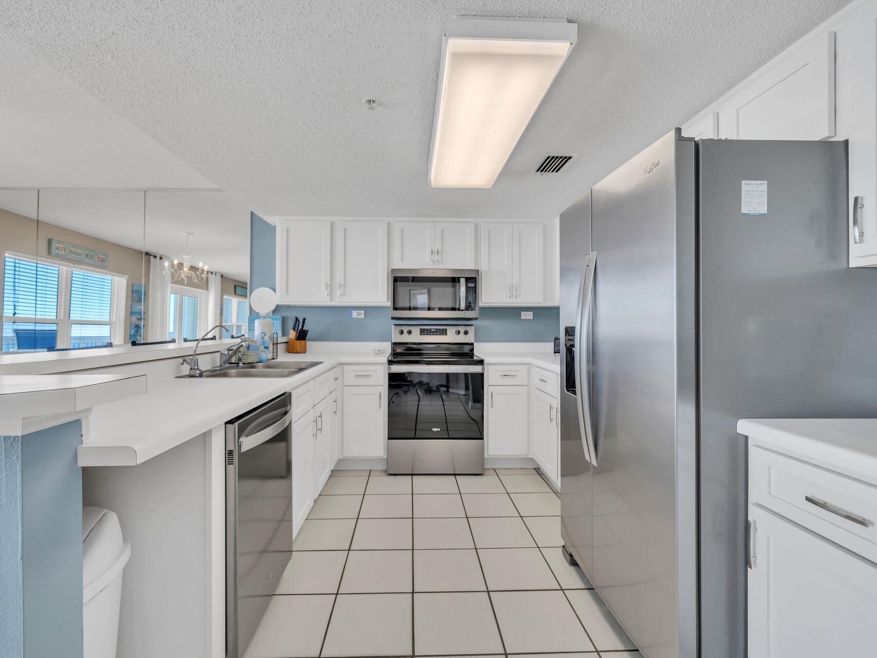 790 Santa Rosa Boulevard, Unit 6002 Fort Walton Beach, FL 32548 - Photo 6 of 42 a kitchen with a sink a counter top space stainless steel appliances and cabinets