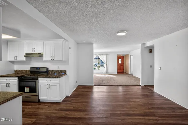 a view of kitchen with microwave and cabinets