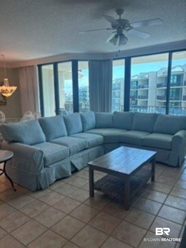 27580 Canal Road, Unit 1423 Orange Beach, AL 36561 - Photo 3 of 34 Expansive living area featuring floor-to-ceiling windows, tile flooring, and a ceiling fan with integrated lighting