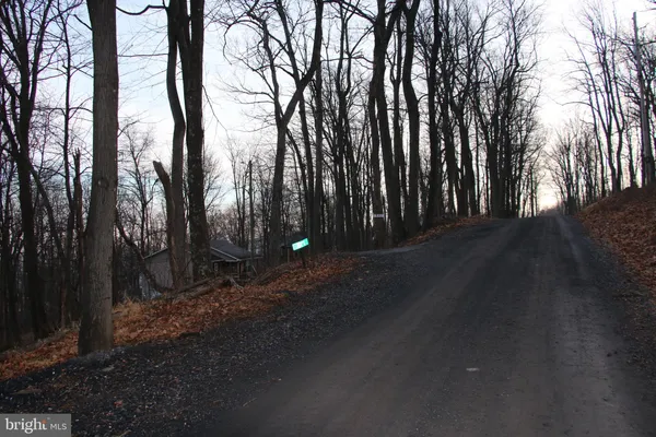 a backyard of a house with lots of green space and outdoor seating