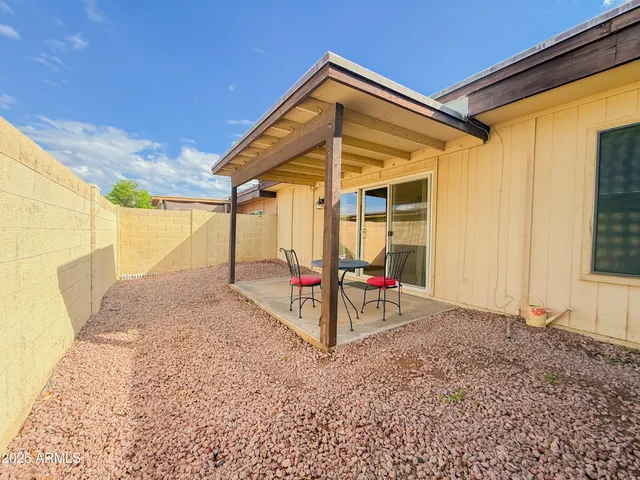 a view of a backyard with table and chairs