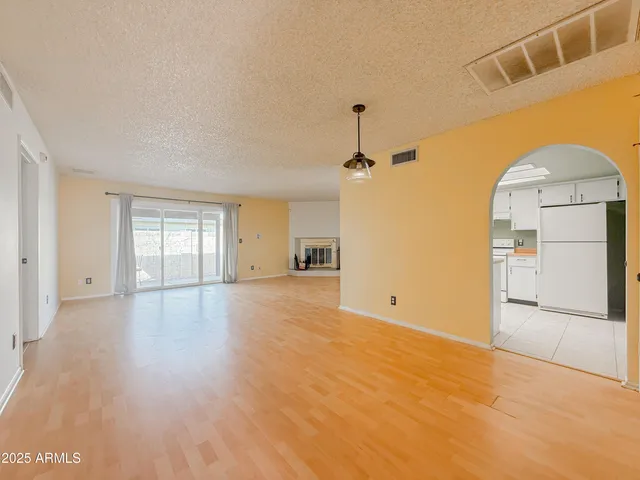 a view of empty room with wooden floor and cabinet