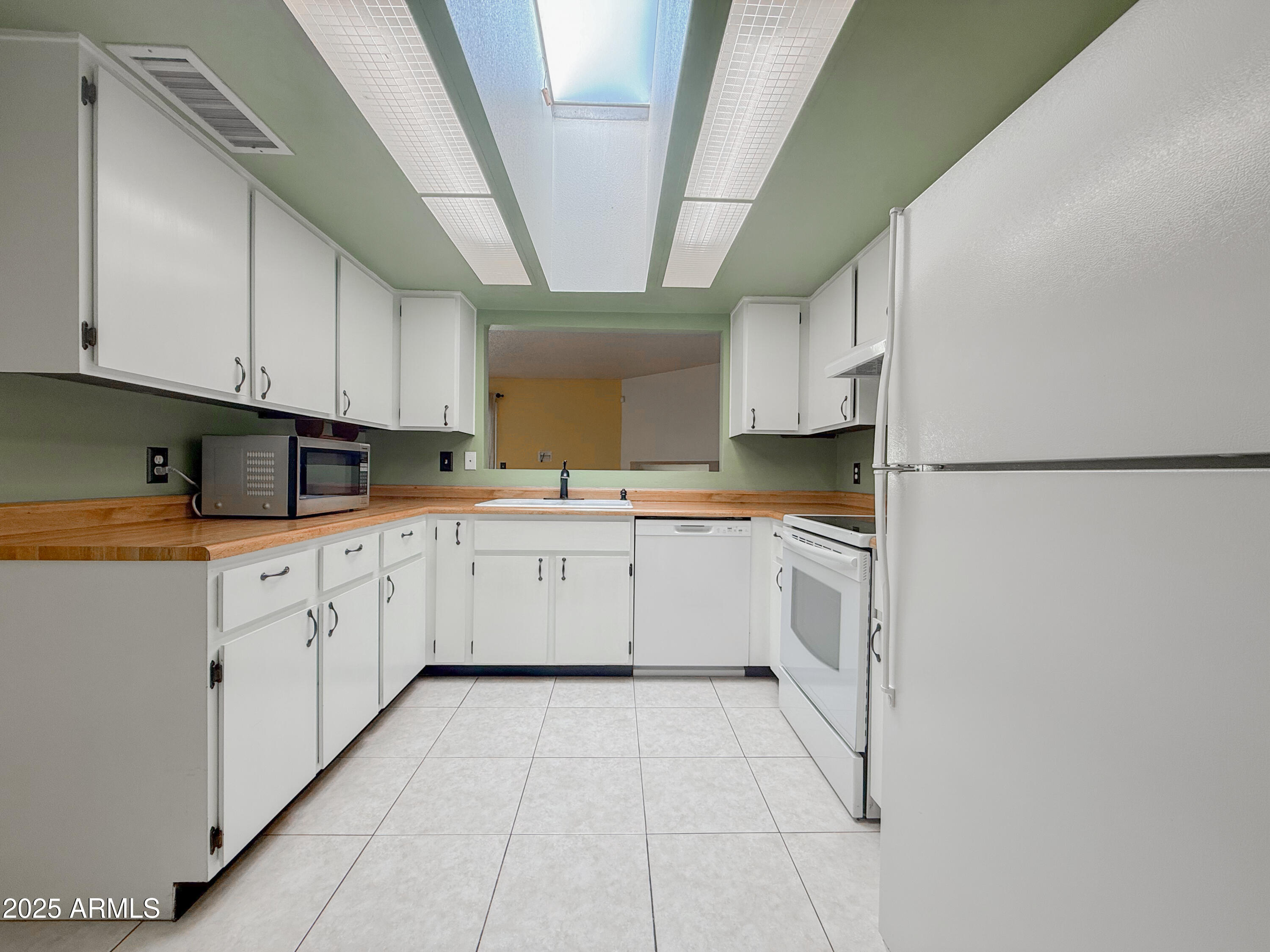 850 West Duke Drive Tempe, AZ 85283 - Photo 8 of 18 a kitchen with granite countertop white cabinets and white appliances