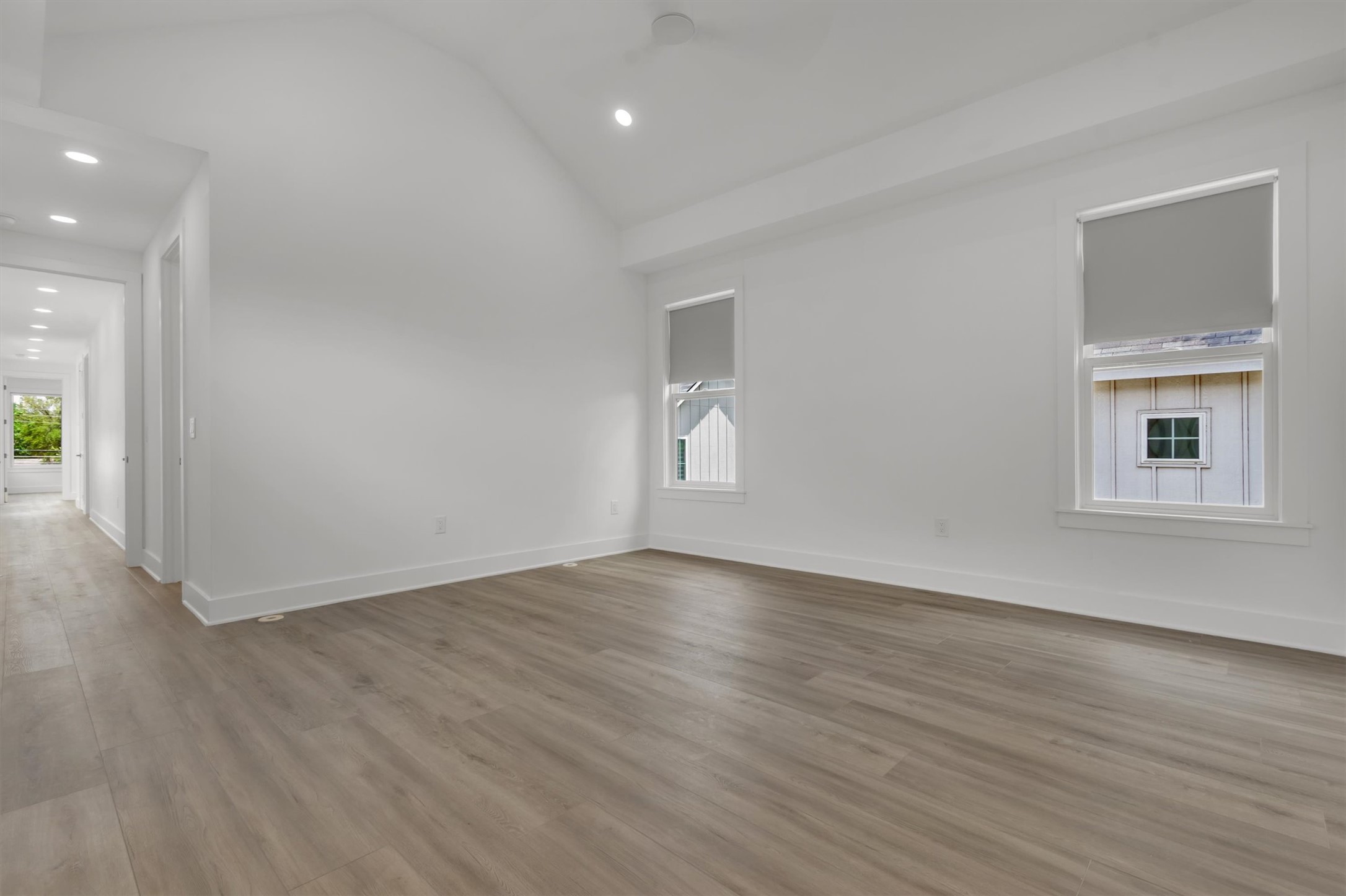 3101 Lyons Road Austin, TX 78702 - Photo 26 of 40 A spacious, naturally illuminated room features vaulted ceilings and light-toned wood flooring, offering a versatile living area.