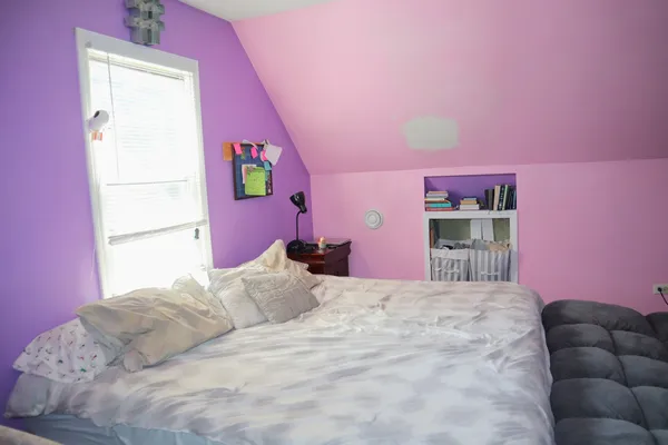 a bedroom with a bed and a couch