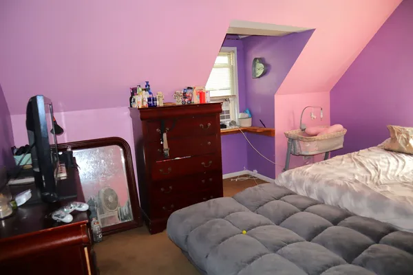 a bedroom with a bed and a dresser