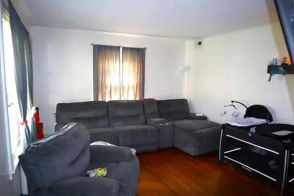 a living room with furniture a air conditioner and a window
