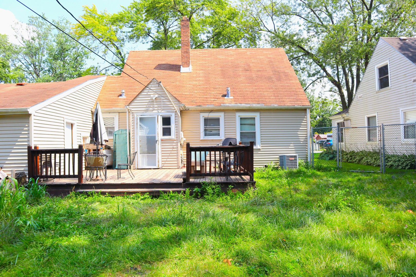 15634 Ridgeway Avenue Markham, IL 60428 - Photo 30 of 30 a front view of a house with a garden and deck