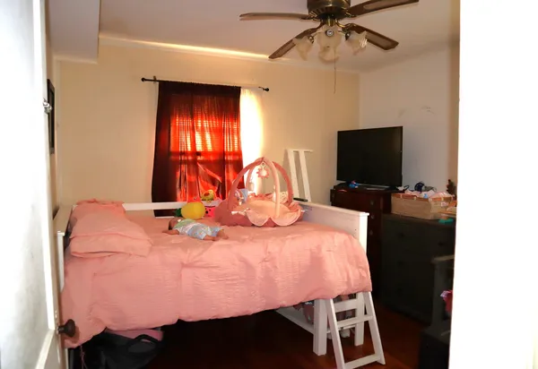 a bedroom with a bed and a flat screen tv