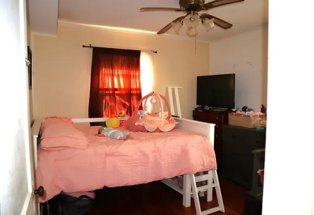 a bedroom with a bed and a flat screen tv