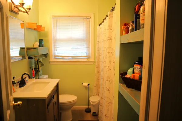 a bathroom with a sink a toilet and a mirror