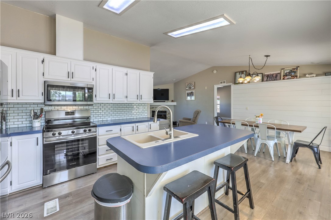 348 Tres Palomas Street Overton, NV 89040 - Photo 16 of 41 A well-lit kitchen with sleek appliances and an inviting island, perfect for casual dining.