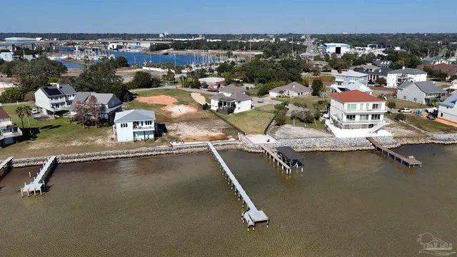 an aerial view of a house with a swimming pool and outdoor seating