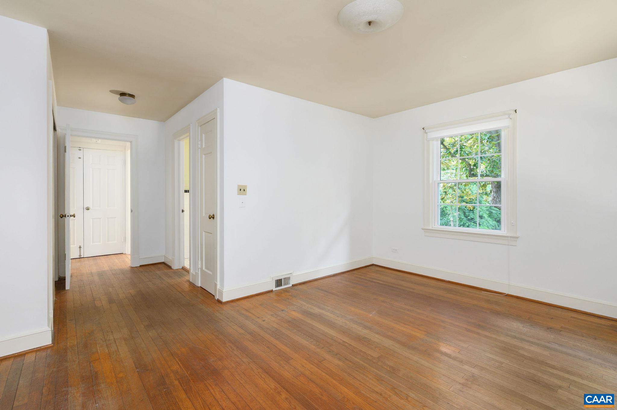 906 Old Farm Road Charlottesville, VA 22903 - Photo 24 of 46 an empty room with wooden floor and windows