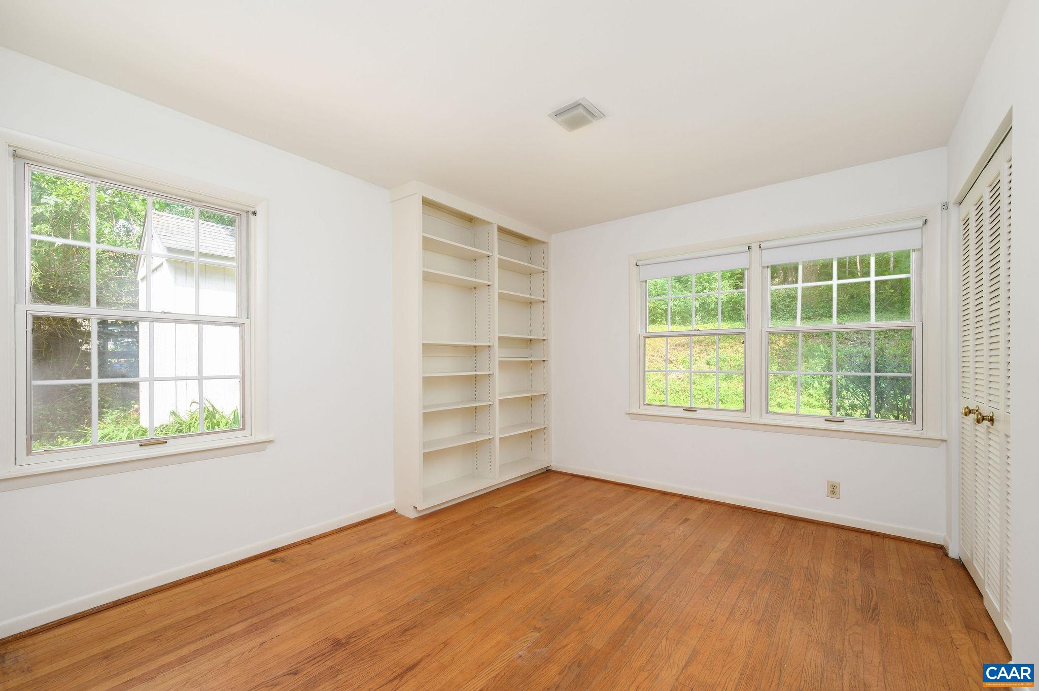 906 Old Farm Road Charlottesville, VA 22903 - Photo 32 of 46 an empty room with wooden floor and windows