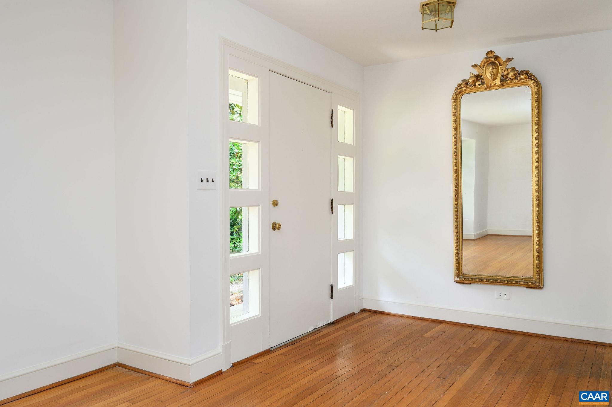 906 Old Farm Road Charlottesville, VA 22903 - Photo 4 of 46 a view of an empty room with wooden floor and a window