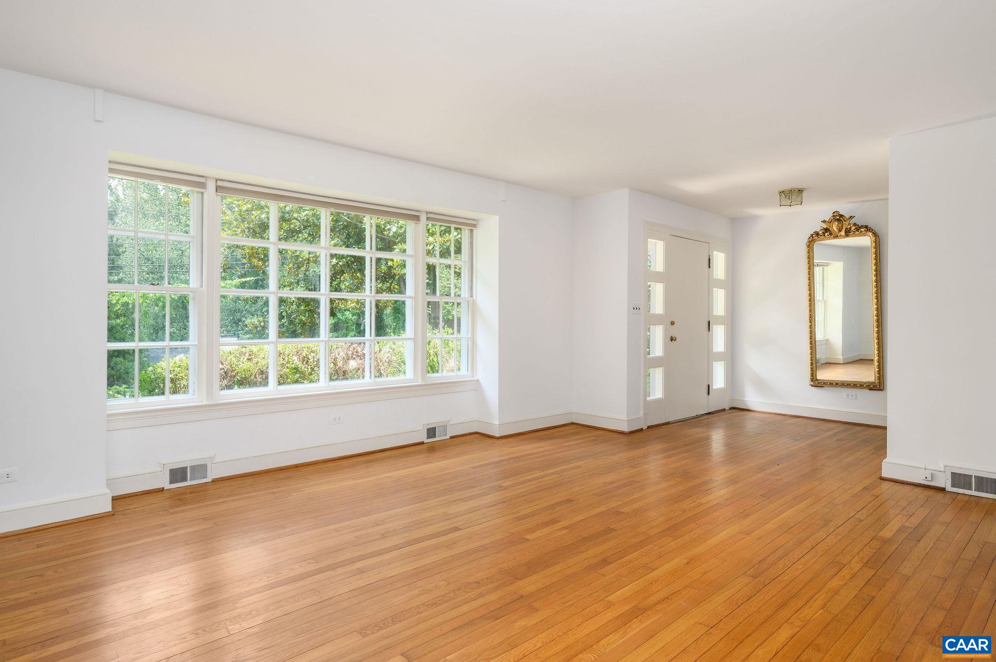906 Old Farm Road Charlottesville, VA 22903 - Photo 7 of 46 a view of an empty room with wooden floor and a window