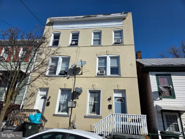 a view of a brick house with many windows