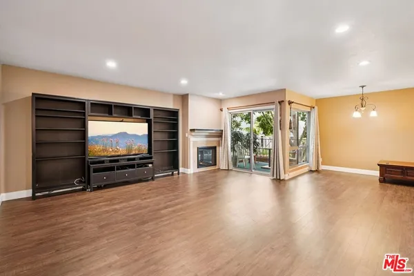 a view of room with wooden floor and windows