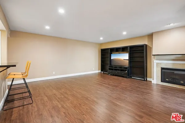 a view of room with furniture and wooden floor