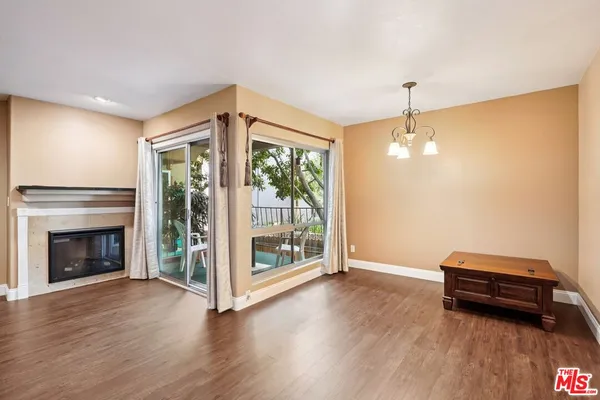 a view of livingroom with furniture wooden floor fireplace and window