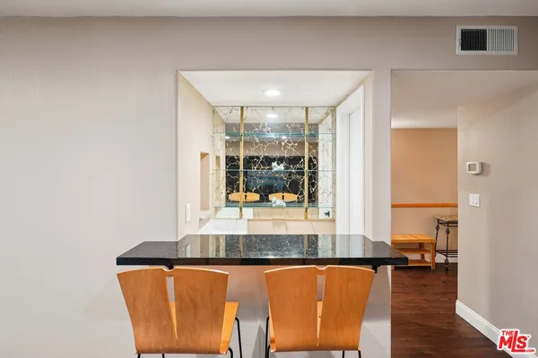 a view of kitchen with granite countertop window and dining table