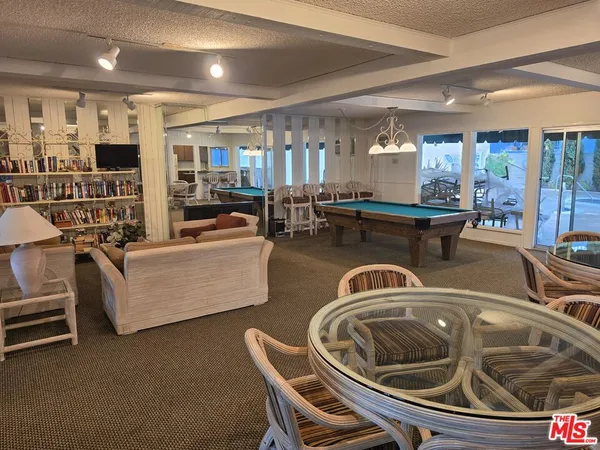 a living room with couches and kitchen view