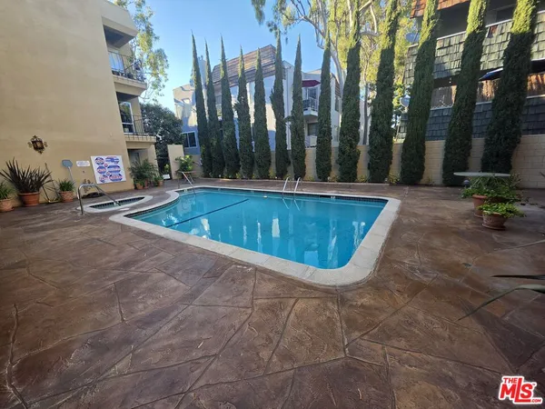 a swimming pool with outdoor seating and yard