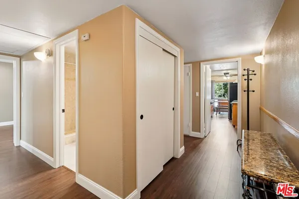a view of hallway with wooden floor