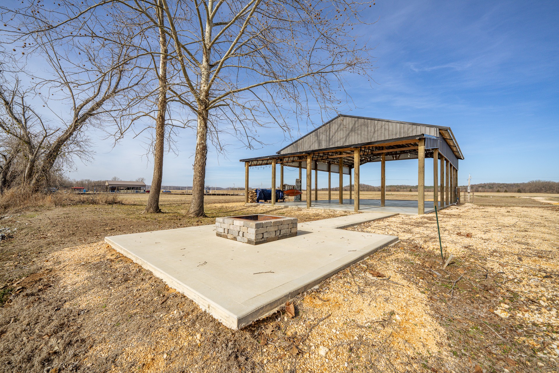 235 Hardin Bottom River Road Clifton, TN 38425 - Photo 20 of 42 a roof deck with table and chairs under an umbrella