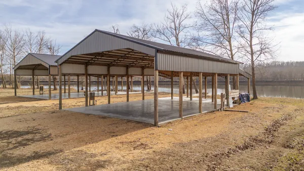 a view of a house with a yard and wooden fence