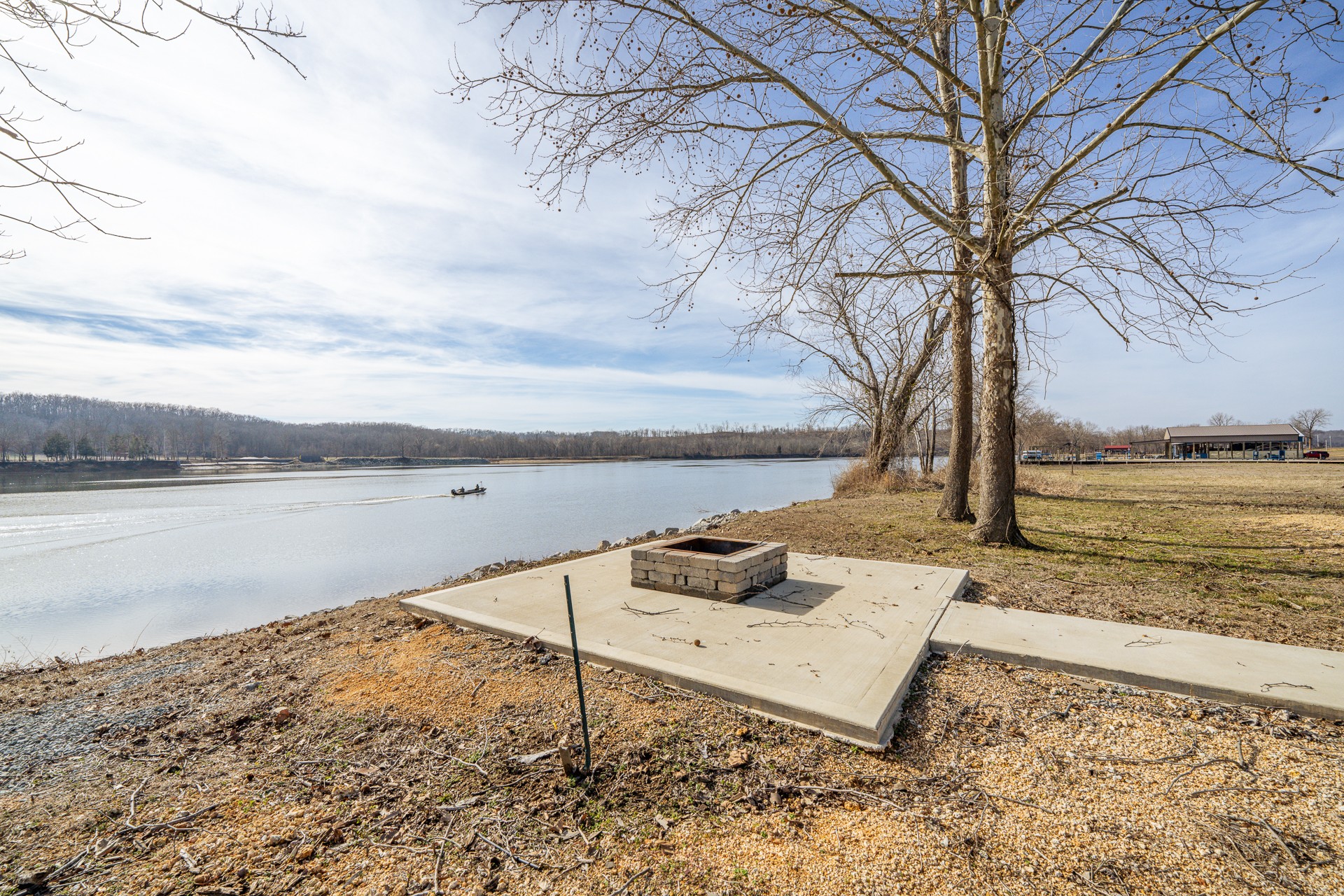 235 Hardin Bottom River Road Clifton, TN 38425 - Photo 42 of 42 a view of a lake with a yard and a large tree