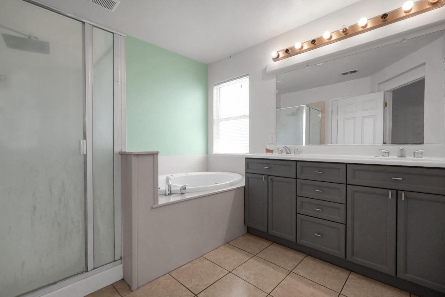 1412 Red Ribbons Lane Manteca, CA 95337 - Photo 22 of 32 a bathroom with a double vanity sink and mirror