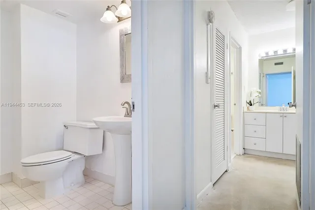 a bathroom with a toilet a sink and shower